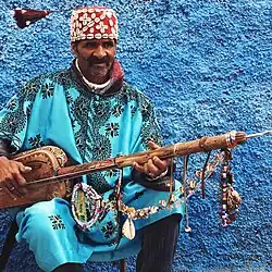Image 52A Gnawa street performer wearing traditional Gnawi clothing in Rabat's Qasbat al-Widaya (from Culture of Morocco)