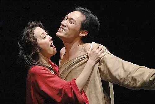 A man leaning into a woman.