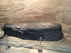 A stone fish carving in a museum
