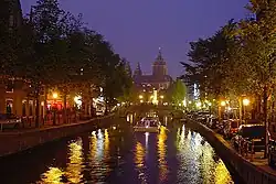 Oudezijds Voorburgwal and silhouette of St. Nicholas' Basilica by night