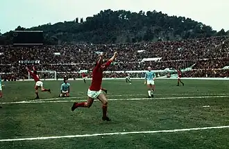 Giancarlo De Sisti and teammates, arms upraised. An opponent had fallen to his knees.