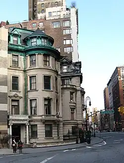 A townhouse at 1 Riverside Drive, at the corner with 72nd Street. The townhouse has a stone facade and metal roof.