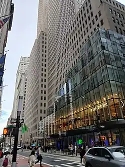 The glass annex to 1 Wall Street as seen from across Broadway. The original building is visible at left, and the first annex is visible behind the glass structure at right.