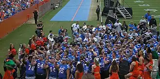 Players and cheerleaders standing together after a game