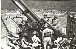 Gunners working on 3.7-inch (94 mm) heavy anti-aircraft gun. 1943.[gallery 21]