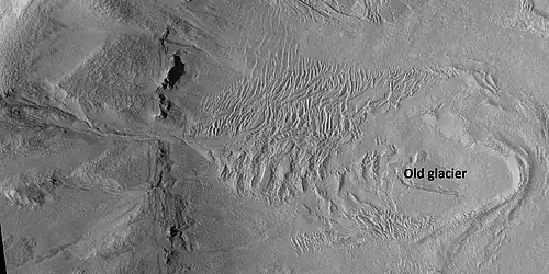 Glacier and gullies, as seen by HiRISE under HiWish program Some researchers suggest that gullies come after glaciers. Location is Casius quadrangle.