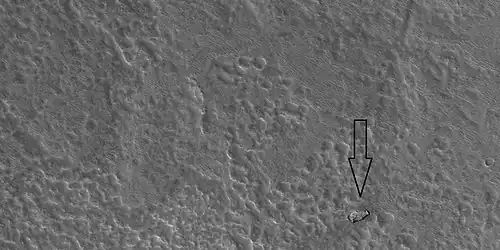 Out of place rock, as seen by HiRISE under HiWish program The arrow points to a large rock that is definitely out of place. It may be a meteorite or it may have been tossed here by a nearby impact.