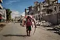 Image 9A man carries a huge hammerhead shark through the streets of Mogadishu