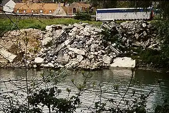 Aa river, its banks shored up with heavy rubble