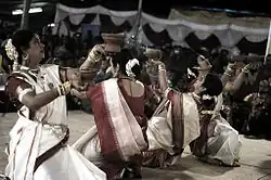 Aarti dance is performed by women dressed in garad sari in Bangalore.