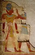 Fragment of a painted relief of pharaoh Ramesses II being accompanied by Horus