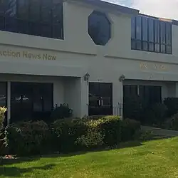 An office building exterior with one sign that reads "Action News Now"