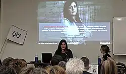 Amelia Tiganus, a survivor of human trafficking, at a talk organized by the Gafas Moradas association. She coordinates the Feminidio.net website.