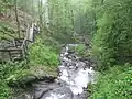 View looking downward showing the stairs of the trail alongside of the waterfall