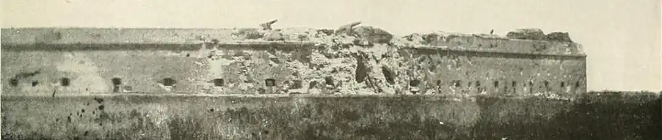 panoramic photo across swamp showing pot-marked fort (a) south wall (left) and (b) east wall (right), (c) two large holes in southeast corner