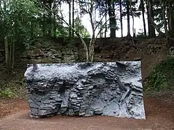 Single block carved by the artist to resemble the outcrop in the background.