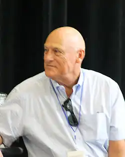 Art Howe, in a button down shirt, turning to his right