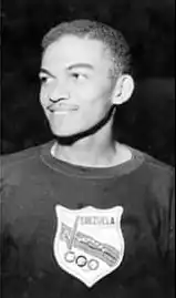 Asnoldo Devonish pictured from just below the chest up and looking off to the side. Image is in black and white.