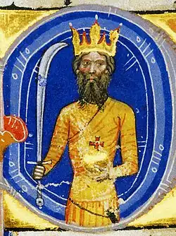 Gold depiction of a bearded king with a crown on his head, a sabre in his right hand and an orb in his left hand within a blue circle