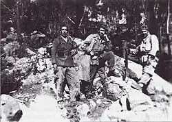 Three men in a mountain landscape