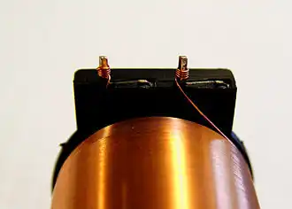 Termination pillar for a coil