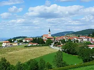 The church and surrounding buildings, in Aveize