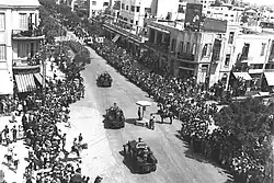 British armoured vehicles parading through Allenby Street in Tel Aviv, in honour of the Silver Jubilee of King George V
