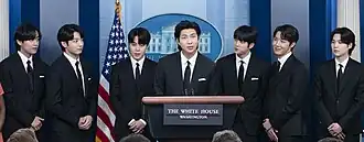 BTS at the White House in May 2022 (left to right): V, Jung Kook, Jimin, RM, Jin, J-Hope, and Suga