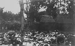Corpses of the puputan at Denpasar. Dutch troops are standing on the left.