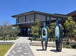 A pair of sculptures representing people as described below