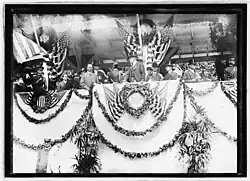 A black and white photograph of President Woodrow Wilson in the reviewing stand