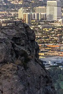 Hikers climb the summit of Bee Rock in Griffith Park, Los Angeles.