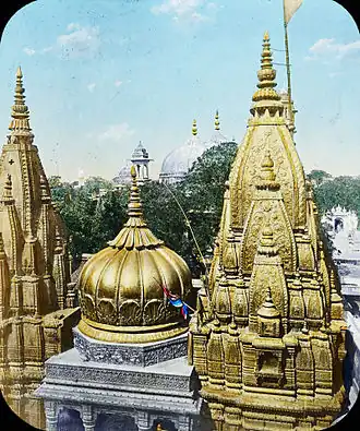 The Kashi Vishwanath Temple was destroyed by the army of Qutb ud-Din Aibak in 1194 CE. Since then, it has been demolished twice (in the 1400s, and 1669 CE) and rebuilt four times (in the 1200s and twice in the 1500s). The current structure was built by Ahilyabai Holkar on an adjacent site after the demolition by Aurangzeb. Shown is the current temple, with a gold temple roof, donated by Ranjit Singh in 1835.[138][139]