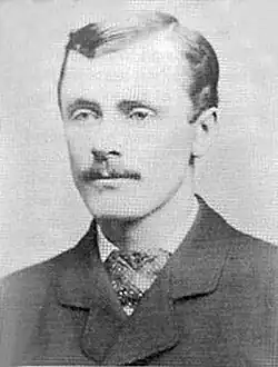 Portrait photograph of a middle-aged man with mustache