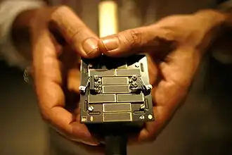 A small metal cube covered in electrical equipment