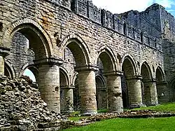 Exterior view of the nave from the south west, showing the bluntly pointed arches. Central tower to right.