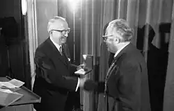 Walter Hallstein on stage, shaking hands while receiving prize