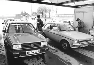 East German border guards check cars on the first day of visa-free entry into East Germany for West Berlin and West Germany citizens on 24 December 1989.