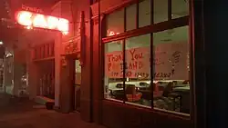 Photograph of a building's exterior with a sign in the window reading, "Thank you Portland for 20 tasty years!" along with the restaurant's social media details