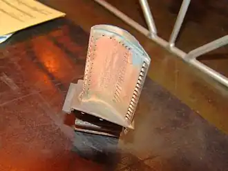 A used CFM56 high pressure turbine blade. New blades have 3 different-depth notches at the tip to aid visual assessment (using a borescope) of rubbed away material and consequent increase in tip clearance. 0.25 mm of lost blade-tip causes a 10 deg C loss of EGT margin.[152]