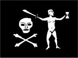 Flag of Jean Thomas Dulaien, described as “The flag was black, with a skull and crossbones below on the hoist and a naked man holding a cutlass in one hand and over the skull and bones and an hourglass in the other, on the fly.” There is no evidence of Walter Kennedy flying this flag; after he mutinied against Bartholomew Roberts, Walter and the rest of the crew retired from piracy and sailed to Ireland.[48]