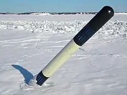A light buoying cardinal mark (east) in pressure of ice in front of Helsinki, Finland in winter. Notice that topmark is not used on a buoy that is subjected to ripping by movements of ice.