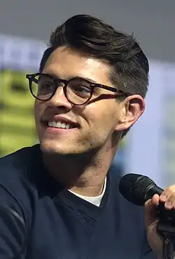 Photo of a bespectacled man with a microphone