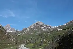 Castelmagno: at right the Santuario di San Magno (Saint Magnus's sanctuary), on background at center the Reina peak and at his feet the Grana valley