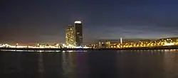 At the left, the Port Olímpic de Barcelona, at the center, the high rises Hotel Arts and Torre Mapfre, and at the right, buildings of the Olympic Village