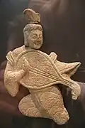 Sandstone carving, showing the typical way a pipa was held when played with plectrum in the early period. Northern Wei dynasty (386–534 AD).