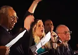 Minister of Foreign Affairs Shimon Peres (far left), singer Miri Aloni, and Prime Minister Rabin (far right) during the rally