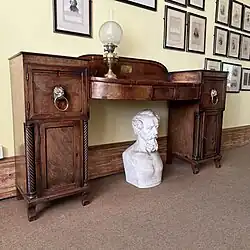 a piece of georgian furniture made of dark wood that was owned by Charles Dickens