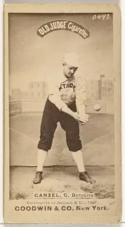 Standing man in baseball uniform catching a ball