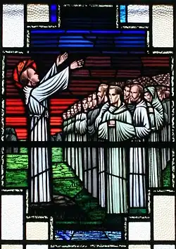 Saint Finnian of Clonard preaches to his monks at Clonard. (Stained glass, 1957).